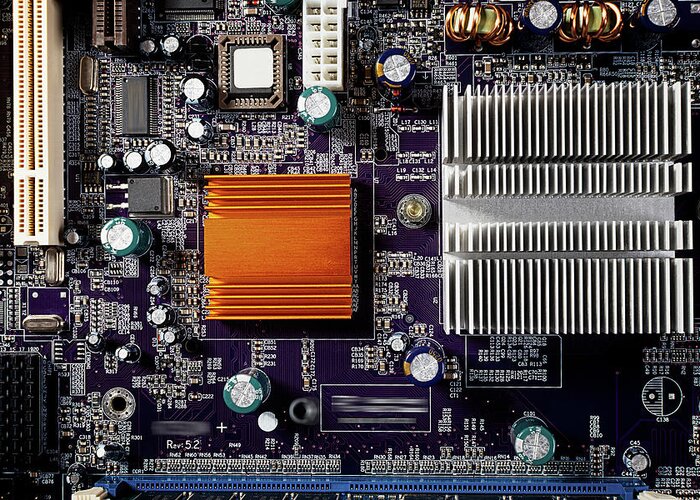 Computer Greeting Card featuring the photograph Mainboard of a pc with electronic components. by Bernhard Schaffer