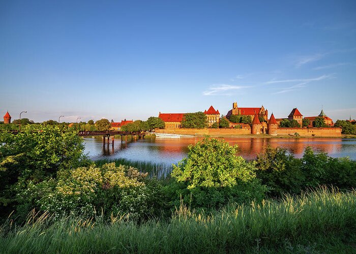 Malbork Greeting Card featuring the photograph Malbork Castle River View At Sunset In Poland by Artur Bogacki