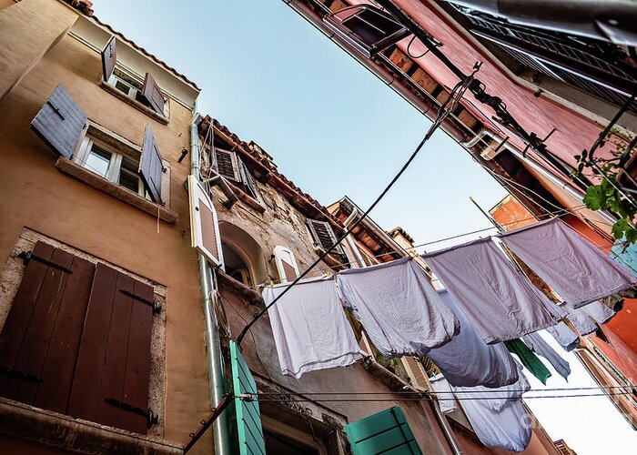 Croatia Greeting Card featuring the photograph Narrow Alley With Old Houses And Freshly Washed Laundry In The City Of Rovinj In Croatia by Andreas Berthold