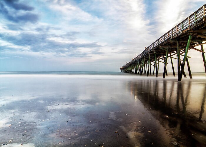 North Carolina Fishing Pier Greeting Card featuring the photograph Oceanna Pier With Blue Skies and Dark Clouds Reflected by Bob Decker