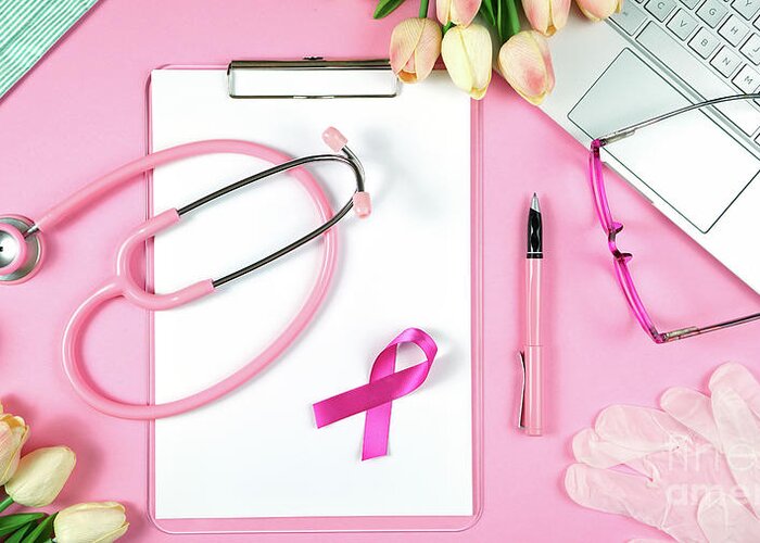 Pink Ribbon Greeting Card featuring the photograph Pink Ribbon Breast Cancer Awareness Month doctor's desk concept. by Milleflore Images