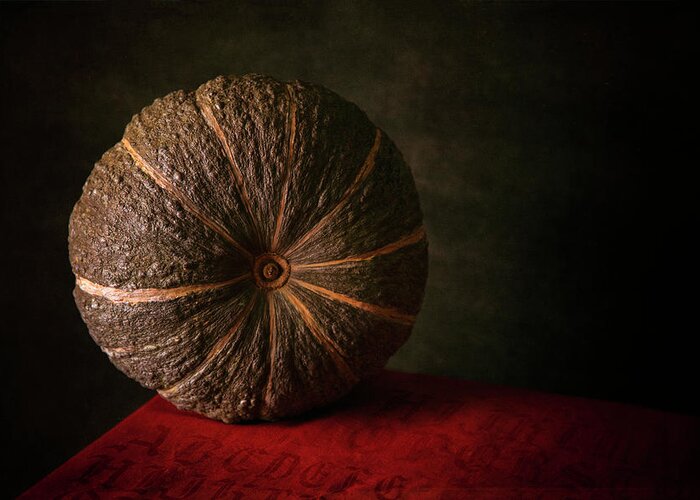 Still Life Greeting Card featuring the photograph Pumpkin on a red table by Valentin Ivantsov
