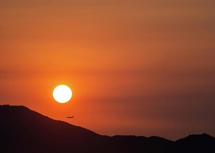 Sunset Greeting Card featuring the photograph Red sunset and plane in flight by Hannes Roeckel