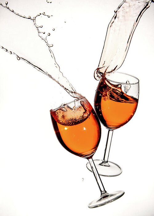Alcohol Greeting Card featuring the photograph Red wine in glasses with splashes on a white background isolated by Michalakis Ppalis