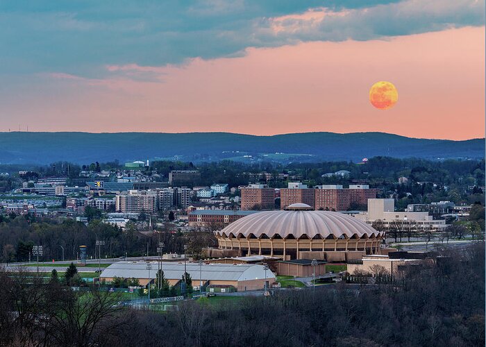 2020 Greeting Card featuring the photograph Super pink moon rises above the WVU coliseum on Evansdale campus by Steven Heap