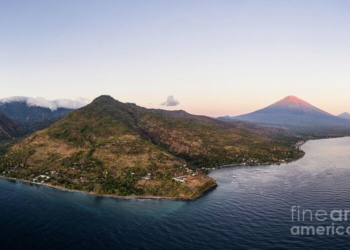 Amed Greeting Card featuring the photograph Twilight over the north Bali coast with the Agung volcano near A by Didier Marti