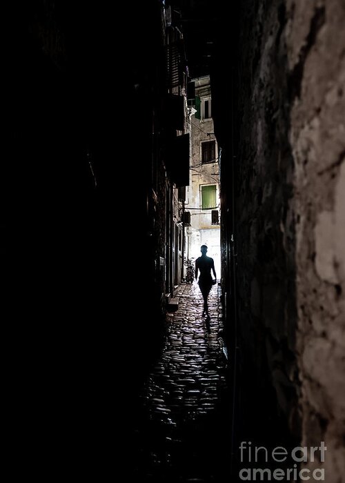 Greeting Card featuring the photograph Young Woman Walks Alone Through Spooky Narrow Abandoned Alley In The Night by Andreas Berthold