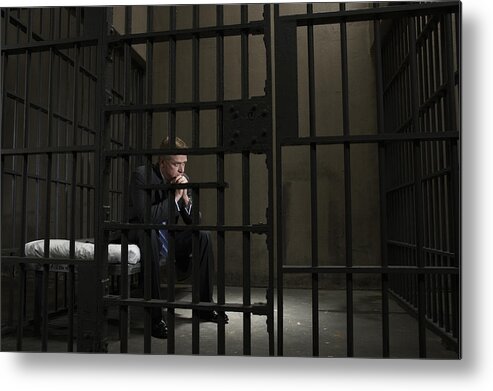 Corporate Business Metal Print featuring the photograph Mature businessman sitting on bed in prison cell #1 by Darrin Klimek