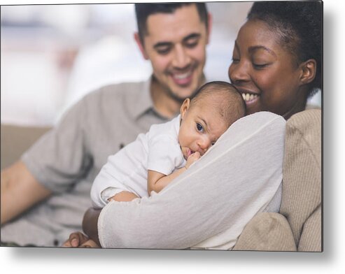 Child Metal Print featuring the photograph New Mom Holds Her Infant to Her Chest #1 by FatCamera