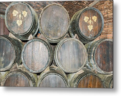 Barrel Metal Print featuring the photograph Old wine barrels in Codorniu winery in Spain #1 by Marek Poplawski