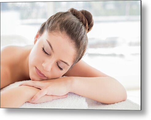 One Person Metal Print featuring the photograph Woman Lying On Towel In Spa #1 by Ian Hooton/science Photo Library