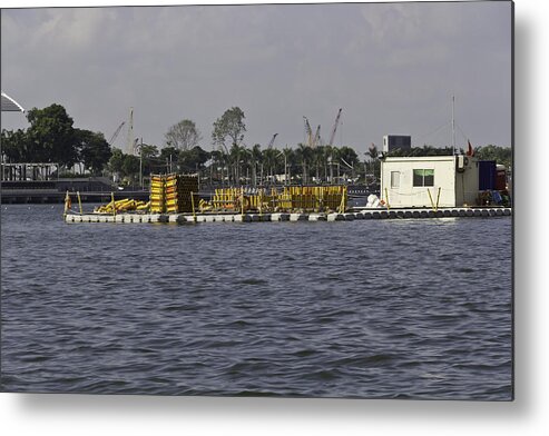 Building Metal Print featuring the photograph A floating platform with a number of pipes used for construction by Ashish Agarwal