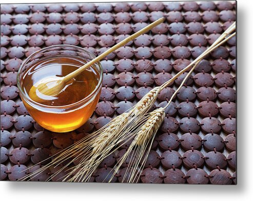 Wood Metal Print featuring the photograph A Glass Bowl Of Honey And Wheat On A by Juan Silva