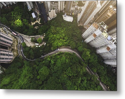 Scenics Metal Print featuring the photograph Aerial view of curve road in forest against buildings in Hong Kong by Kiyoshi Hijiki