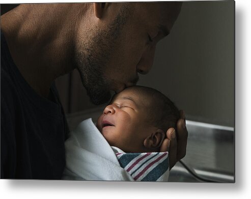 Young Men Metal Print featuring the photograph Black father kissing forehead of newborn son by Ariel Skelley
