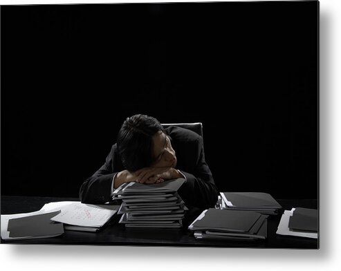 One Man Only Metal Print featuring the photograph Businessman asleep at desk resting head on stack of files by James Woodson