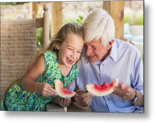 Child Metal Print featuring the photograph Caucasian man and granddaughter eating watermelon by Marc Romanelli