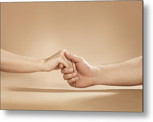 Young Men Metal Print featuring the photograph Close Up Of Man And Woman Holding Hands In Studio by Paper Boat Creative