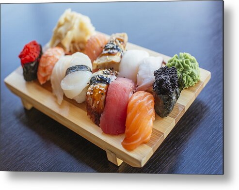 Seaweed Metal Print featuring the photograph Close-up of sushi set on wooden board by Alexander Spatari