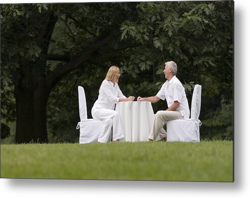 Mid Adult Women Metal Print featuring the photograph Couple dining outdoors by Comstock Images