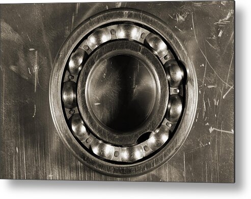 Detail Metal Print featuring the photograph Detailed Titanium Ball Bearing Against Steel by Christian Lagereek