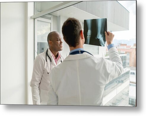Expertise Metal Print featuring the photograph Doctors looking at an x-ray by Andresr