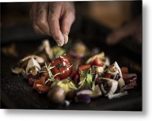 Mature Adult Metal Print featuring the photograph Hand seasoning vegetables ona a baking tray by Westend61