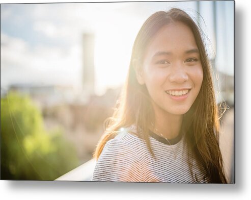 Asian And Indian Ethnicities Metal Print featuring the photograph Happy smiling young asian woman looking over by Mlenny