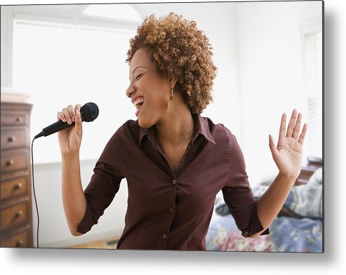 Singer Metal Print featuring the photograph Hispanic woman singing on microphone in bedroom by Jose Luis Pelaez Inc