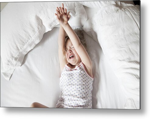 Human Arm Metal Print featuring the photograph Little girl crying in bed by Claudia Burlotti