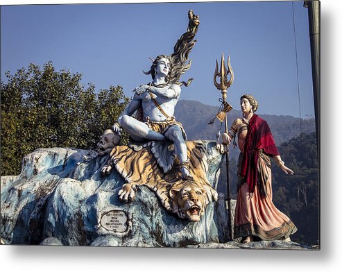 Hinduism Metal Print featuring the photograph Lord Shiva and goddess Parvati statue's in Rishikesh. by Mantosh