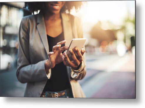 Working Metal Print featuring the photograph Making big plans on her cellphone by PeopleImages