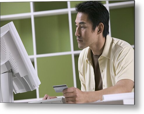 People Metal Print featuring the photograph Man ordering online with credit card by Comstock Images