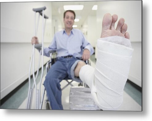 Three Quarter Length Metal Print featuring the photograph Man sitting in wheelchair with broken leg in hospital by ER Productions Limited