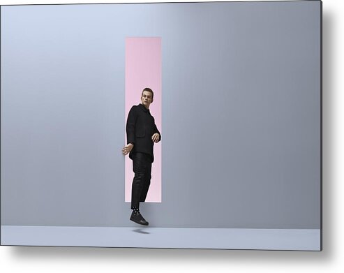 Rectangle Metal Print featuring the photograph Man walking threw rectangular opening in coloured room by Klaus Vedfelt