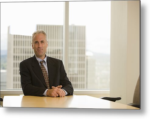 Corporate Business Metal Print featuring the photograph Mature businessman sitting at desk, smiling, portrait by John Giustina