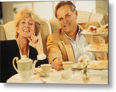 People Metal Print featuring the photograph Mature couple dining out by Comstock