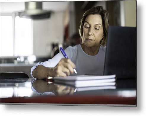 Working Metal Print featuring the photograph Mature woman working at home by FG Trade