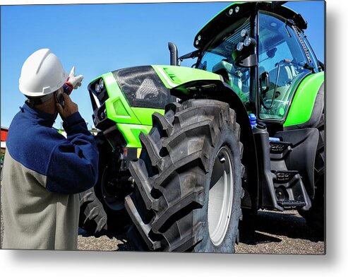 Adult Metal Print featuring the photograph Mechanic On The Phone Pointing At Tractor by Christian Lagerek/science Photo Library