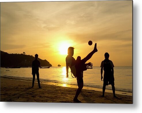 Young Men Metal Print featuring the photograph Men Playing Takraw Ball At Sunset On by Stuart Corlett / Design Pics