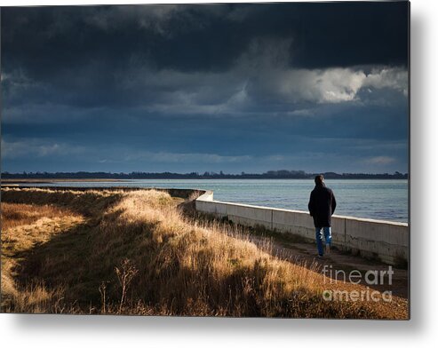 England Metal Print featuring the photograph One Man Walking Alone By Sea Wall In Sunshine On Dramatic Stormy by Peter Noyce