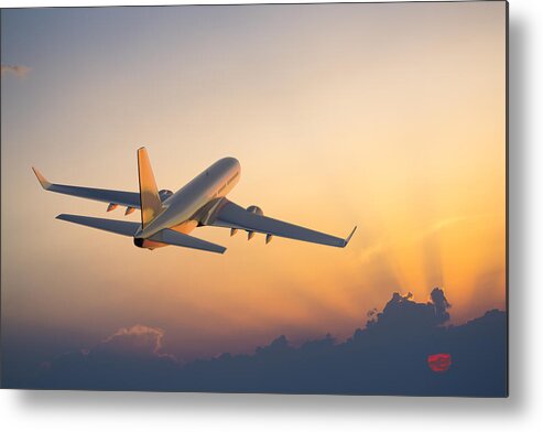 Taking Off Metal Print featuring the photograph Passenger airplane flying above clouds during sunset by Spooh