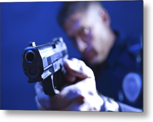 People Metal Print featuring the photograph Police officer aiming gun by Jupiterimages