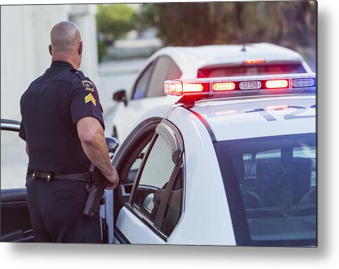 Working Metal Print featuring the photograph Police officer getting out of cruiser by Kali9