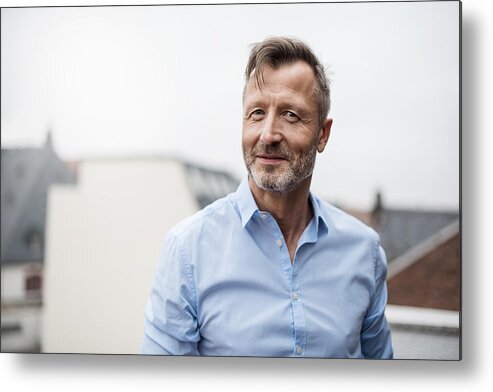 Mature Adult Metal Print featuring the photograph Portrait of smiling mature businessman on roof terrace by Westend61