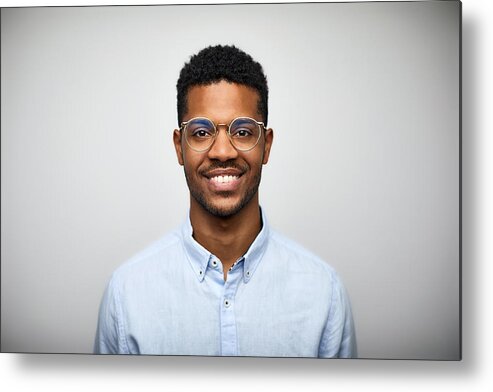 Young Men Metal Print featuring the photograph Portrait of smiling young man wearing eyeglasses by Morsa Images