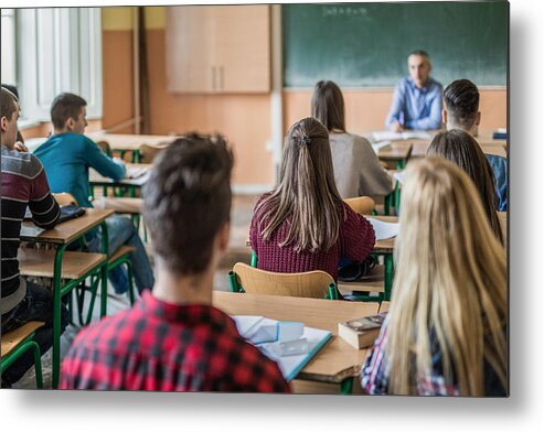Education Metal Print featuring the photograph Rear view of high school students attending a class. by Skynesher
