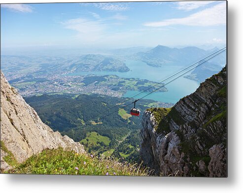 Extreme Terrain Metal Print featuring the photograph Red Overhead Cable Car In Swiss Alps by Stockwerk