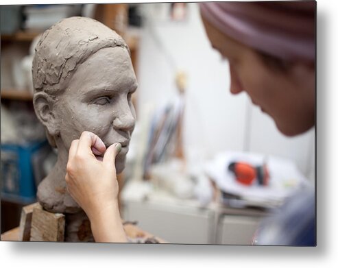 Expertise Metal Print featuring the photograph Sculptor working on head sculpture by Guido Mieth