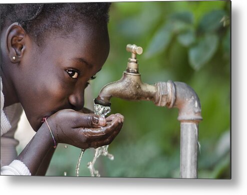 Child Metal Print featuring the photograph Social Issues: African Black Child Drinking Fresh Water From Tap by Borgogniels